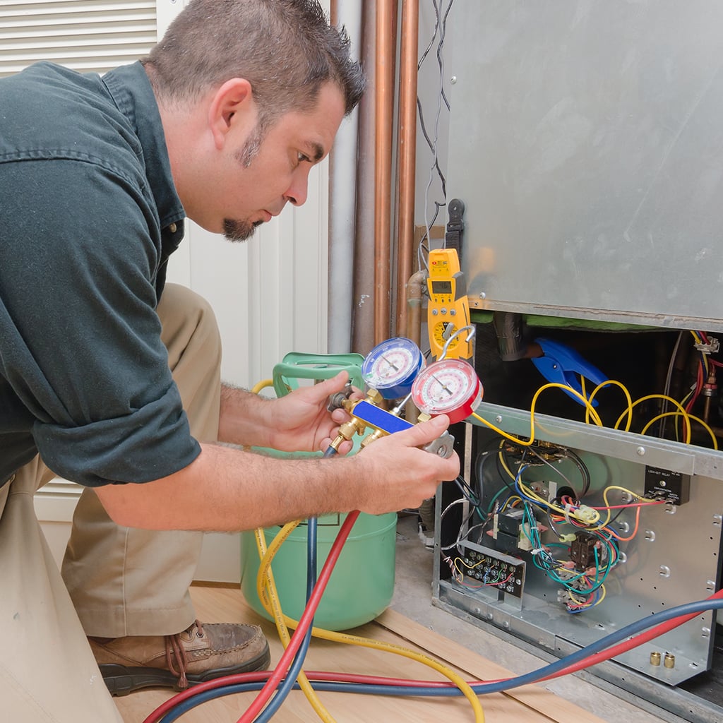 Service Technician fixing furnace.